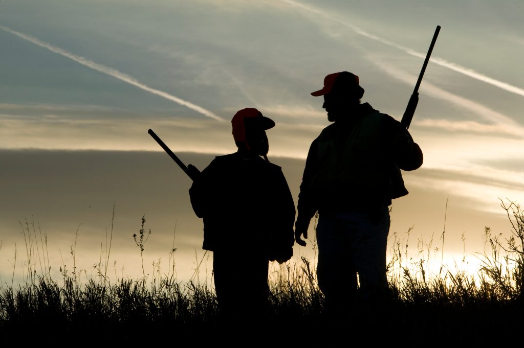 silhouette of parent and child hunting